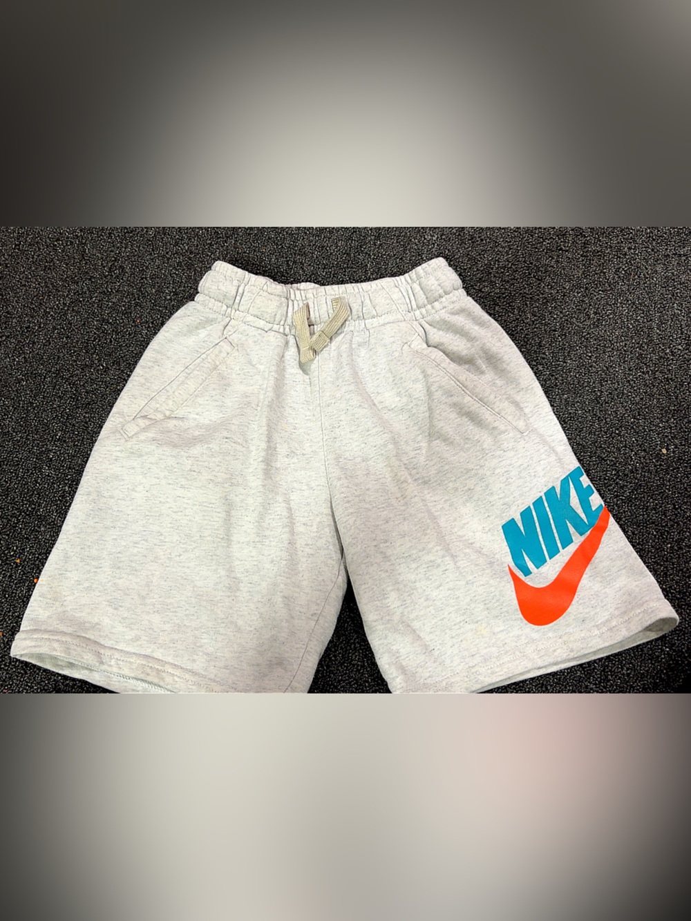 Nike Light Gray Kids Shorts with Orange Swoosh and Blue Logo